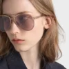 Ochelari de soare Prada cu plăcuța metalică iconică